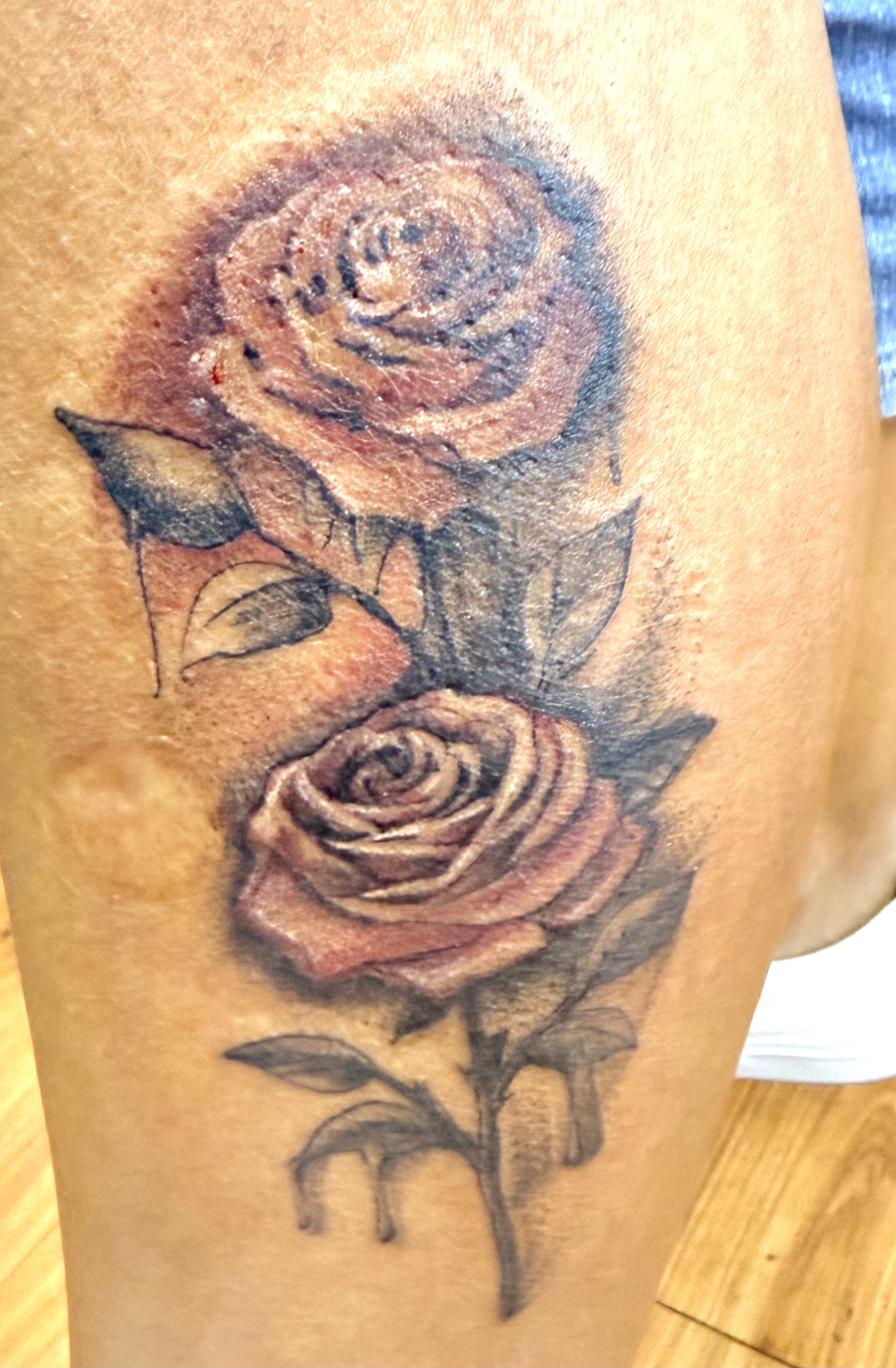 Color realism double rose tattoo — healed roses on the thigh