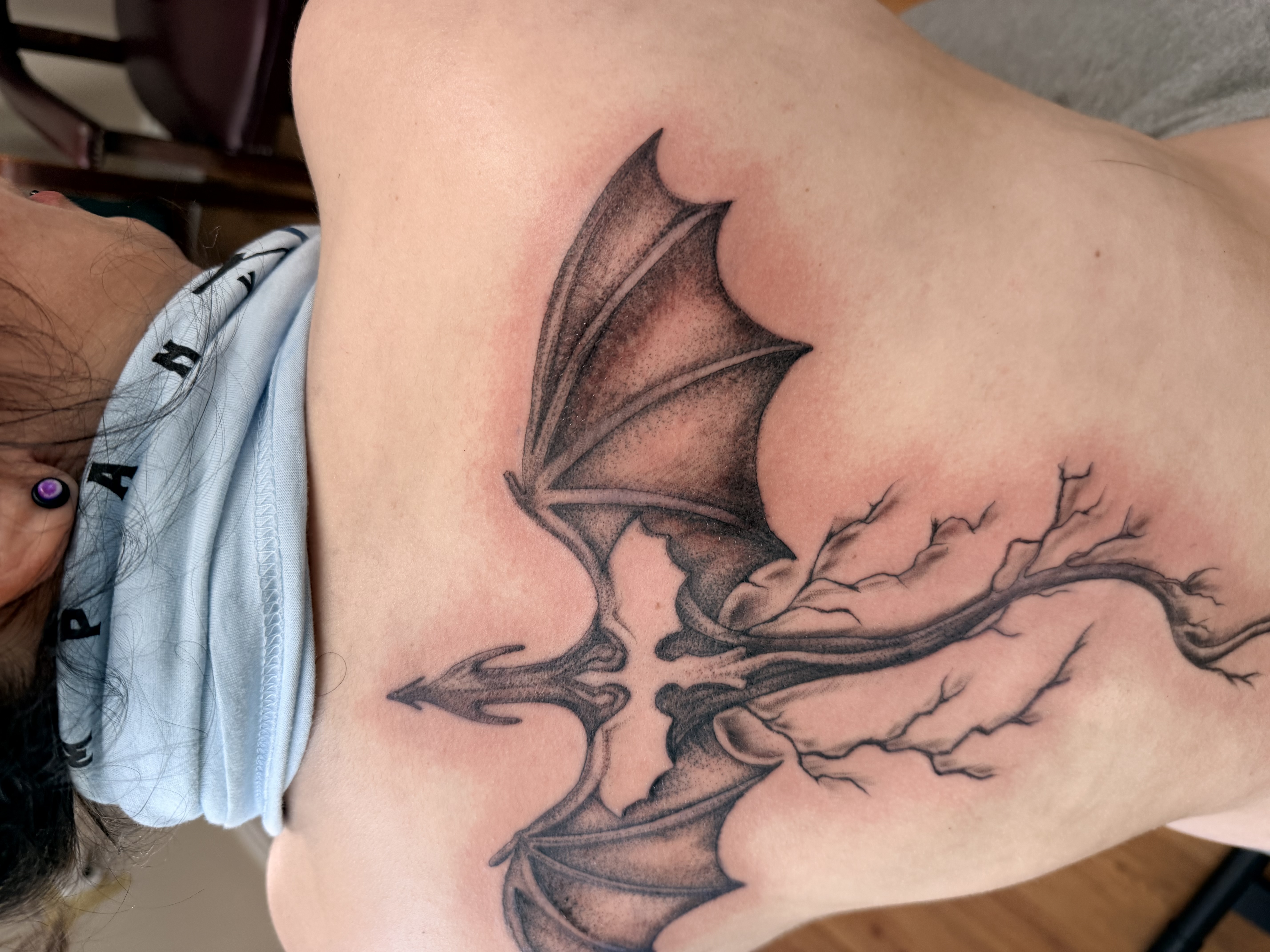 Large black and grey bat with lightning roots back piece — upper and mid back